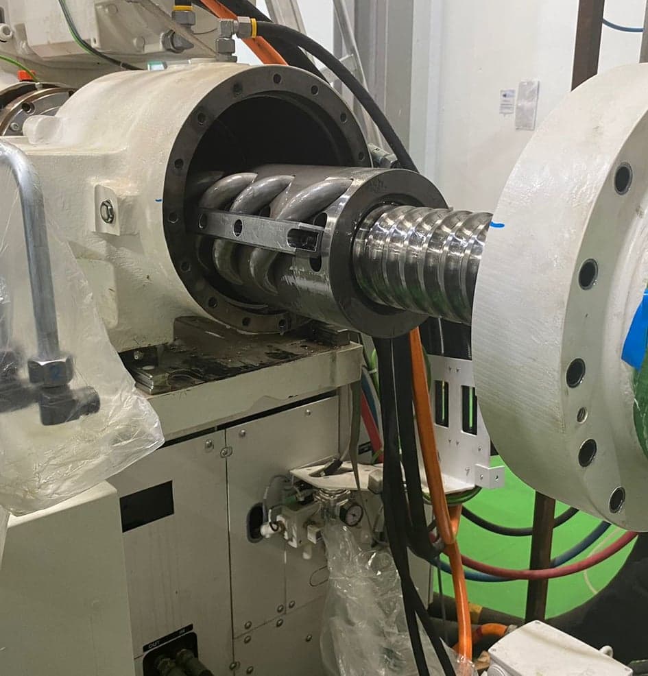 Injector assembly during resealing service on a KraussMaffei machine